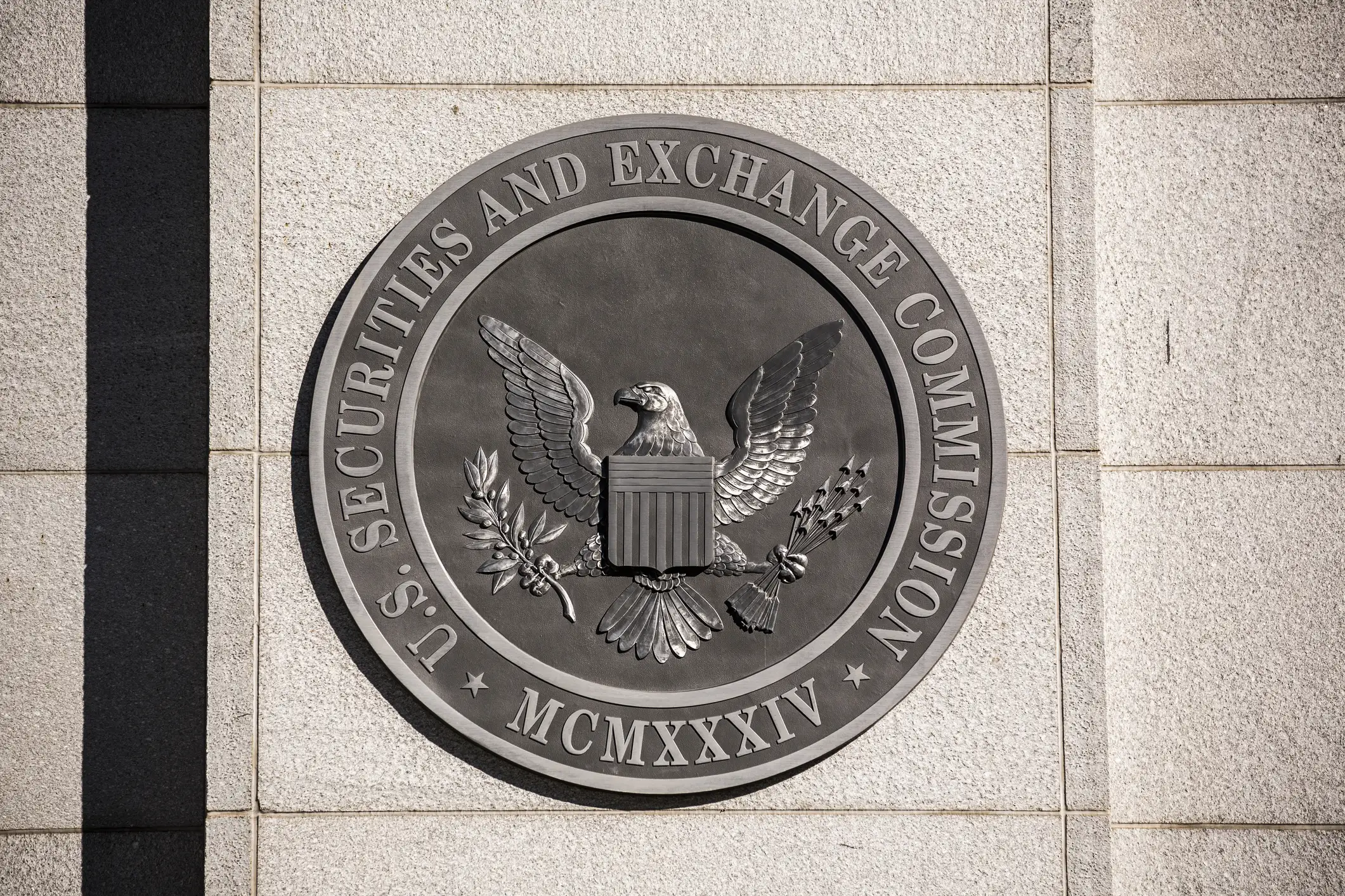 US Securities And Exchange Commission metal emblem on a wall